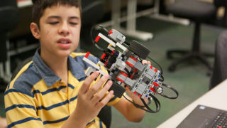 Boy with robotics model